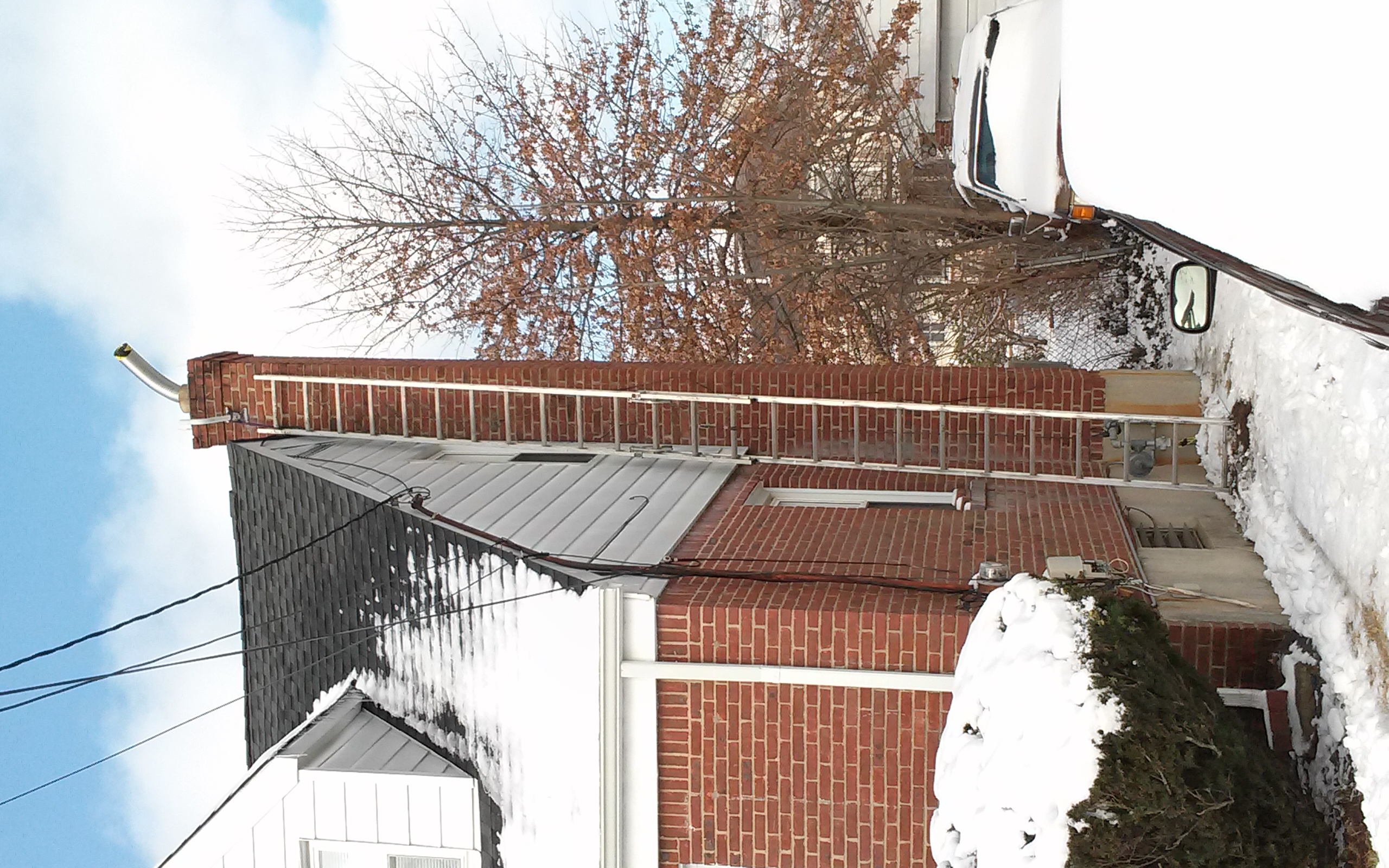 A FINISHED STAINLESS STEEL CHIMNEY LINER INSTALLATION, READY TO PROTECT THE HOME IN MONTAUK